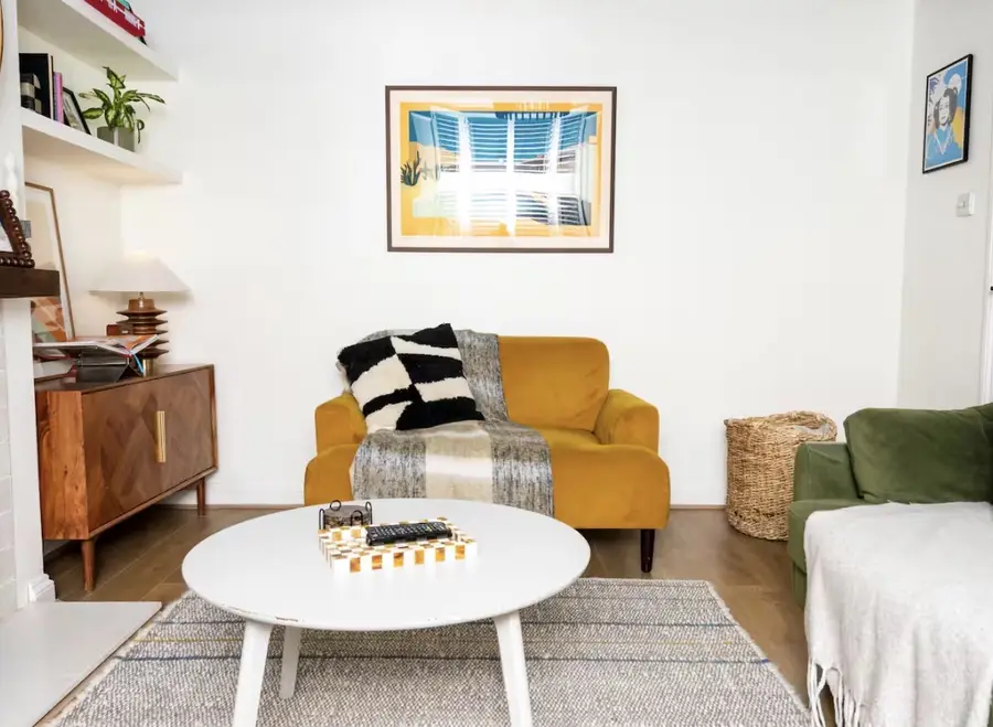Living room with mustard armchair and green sofa